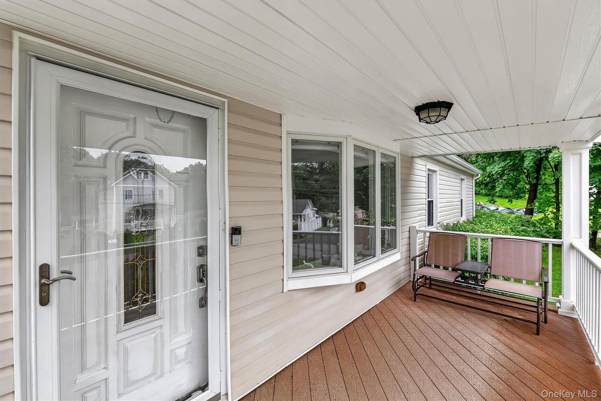 Relaxing front porch offers the perfect spot to enjoy your morning coffee or unwind.