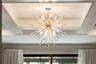 The Rousseau Articulating Chandelier accents the primary bedroom.