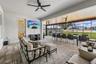 The covered lanai has been extended to create an outdoor oasis with multiple seating areas.