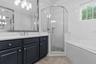 Subway tile wall surrounds shower and tub.