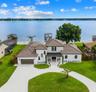 SWEEPING AERIAL VIEW HIGHLIGHTING CUSTOM LANDSCAPING AND LAKE CONWAY