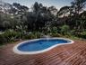 A custom wood pool deck around the free-form pool with a soothing waterfall