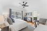 Bedroom with  wood floors, a ceiling fan, a sink, and ensuite bath