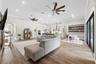 Spacious living room with dual oversized fans.
