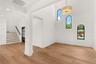 GRACIOUS DINING ROOM SHOWCASING SOARING ARCHED WINDOWS AND A DESIGNER CHANDELIER