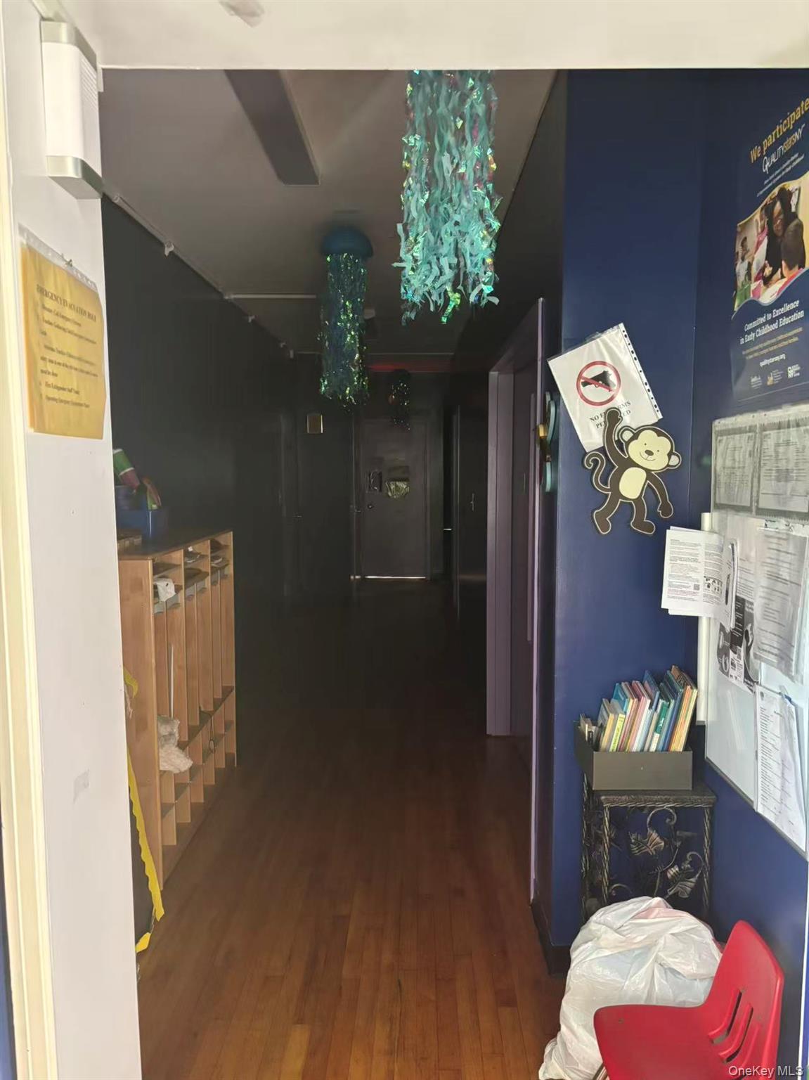 Corridor with hardwood / wood-style flooring