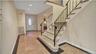 Foyer with visible vents, baseboards, stairway, and granite finish floor