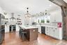 Abundant cabinet space, oversized island and gorgeous farmhouse details