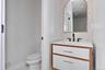Bathroom with vanity and tasteful backsplash
