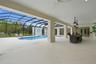 4000 sq ft lanai with covered areas, bar, & outdoor kitchen