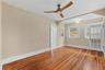 Original heart pine floors and timeless architectural details bring warmth and character to the first-floor bedroom.
