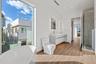Spacious primary bathroom with dual sinks, ample storage and spa-style soaking tub.