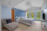The primary suite occupies its own private wing and serves as a luxurious retreat. Featuring vaulted ceilings, additional storage space, and a custom 