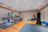 Dedicated fitness space featuring wood-finish flooring, recessed lighting, and a neutral wall palette