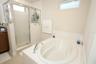 Primary bathroom tub and shower