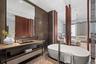 Full bathroom featuring a chandelier, brick floor, a freestanding tub, vanity, and tile walls