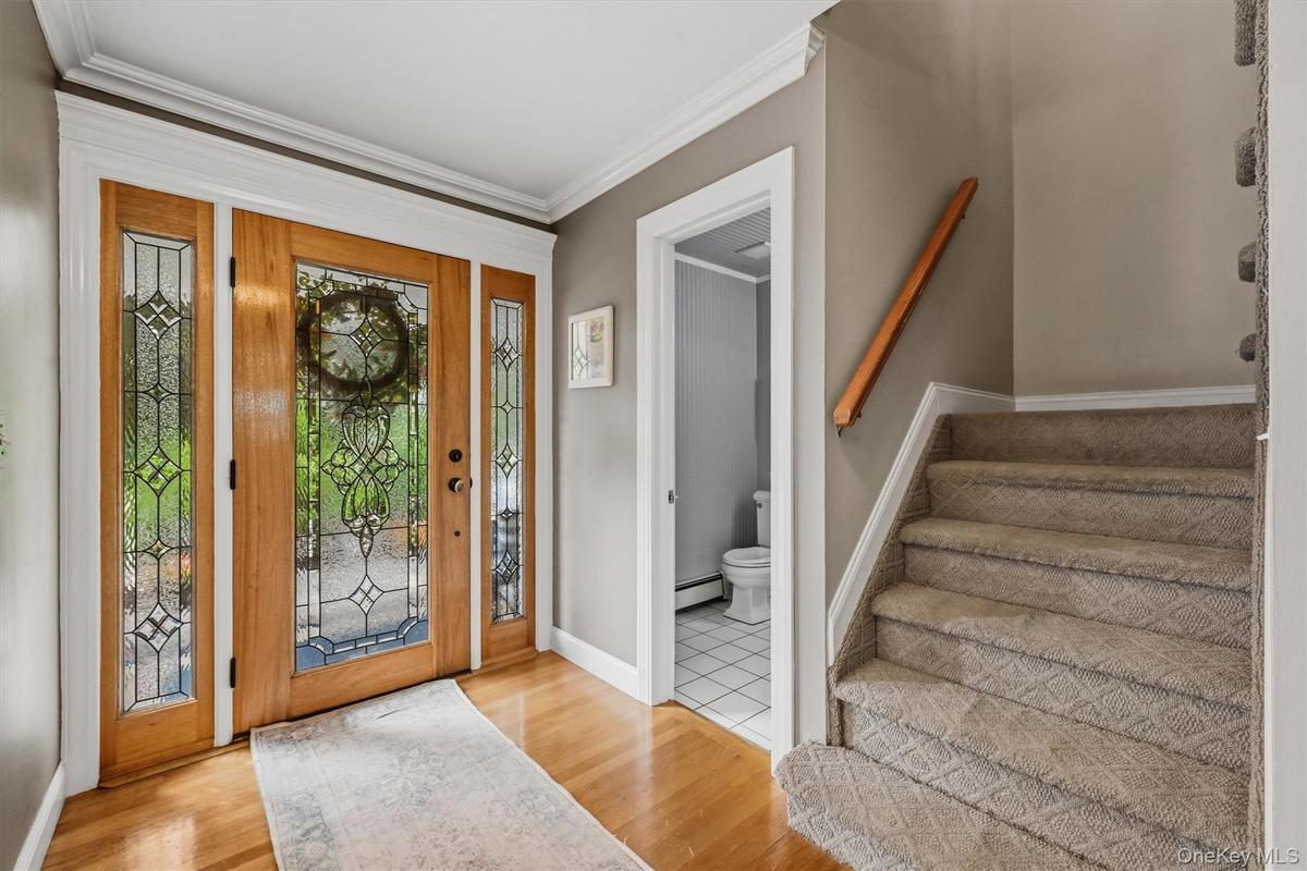 Hardwood floors, crown molding, a solid cherry door and that's just the foyer!