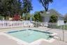 View of swimming pool with a playground and a patio area