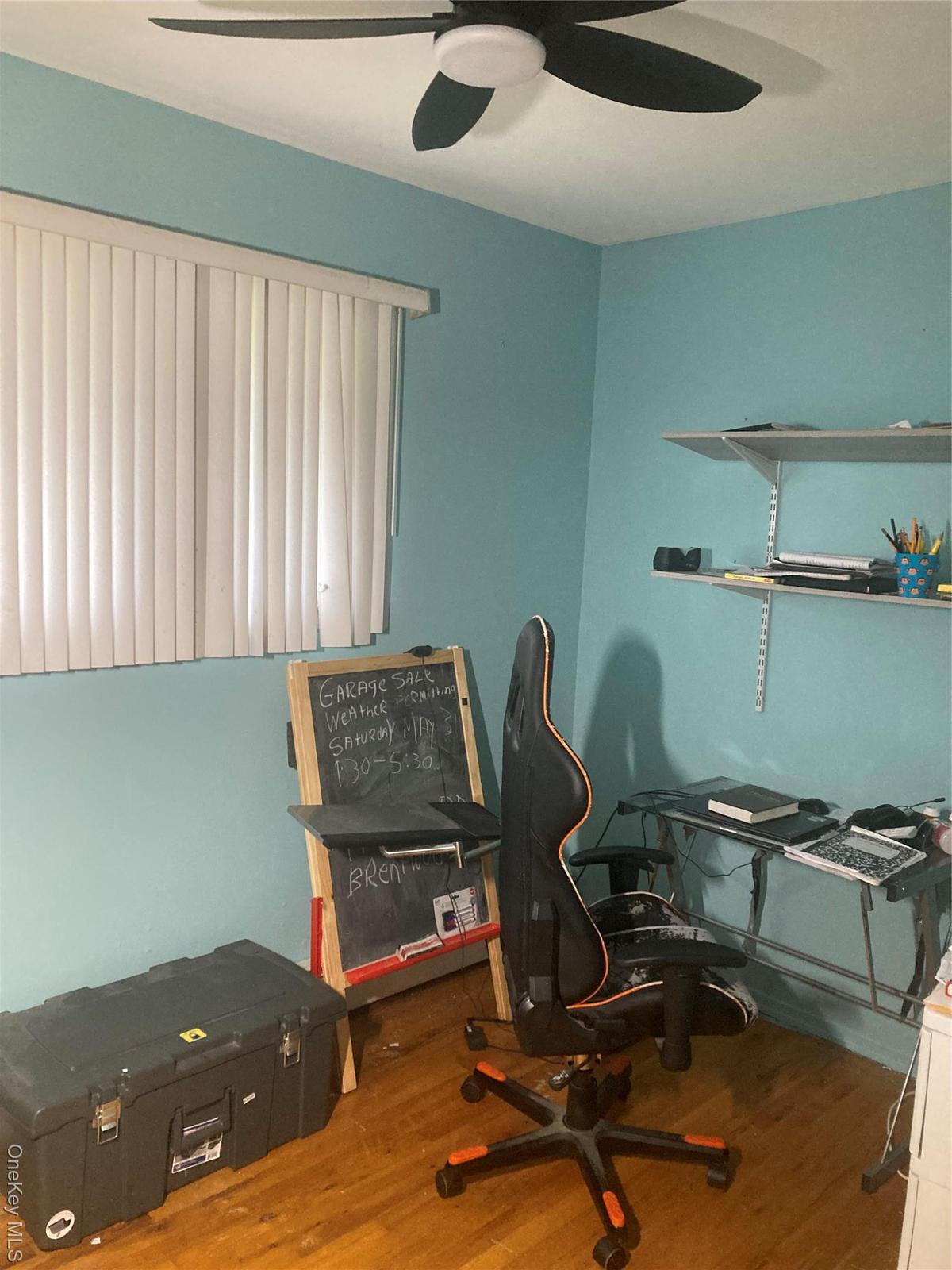 Office with wood finished floors and ceiling fan