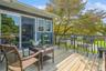 View of wooden deck with sliders into kitchen