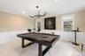 Rec room with marble tiled flooring, billiards, crown molding, a wainscoted wall, and a decorative wall