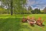 View of grassy yard featuring a fire pit