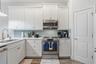 Beautiful watercolor back splash adds beauty to this kitchen