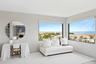 Living area featuring a water view and baseboards