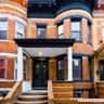 Doorway to property with brick siding, a porch, and french doors