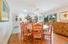 Dining space featuring a ceiling fan, light wood-style flooring, baseboard heating, and plenty of natural light