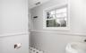 Bathroom with wainscoting and light flooring