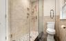 Full bath with a stall shower and tile walls