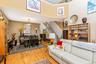 Open-concept living area featuring  a two-story ceiling, and a staircase with white risers and wood treads