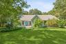 Ranch-style home featuring a front yard and roof with shingles