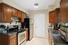 The kitchen has a range, refrigerator, and dishwasher.