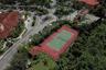 Aerial view of the tennis court and the Guardhouse to the right; Grand Bellagio clubhouse to the left
