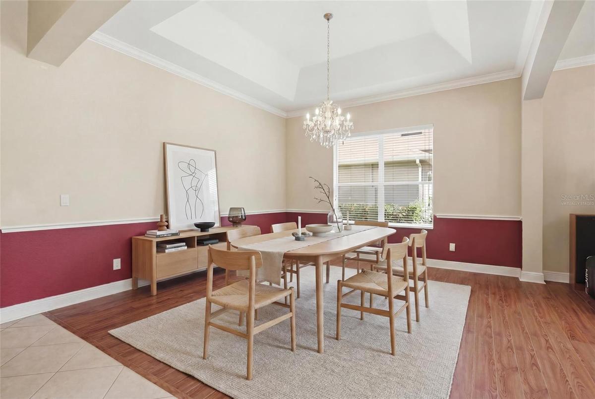 Virtually staged dining room open to the living room