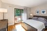 Bedroom with wood finished floors and access to outside