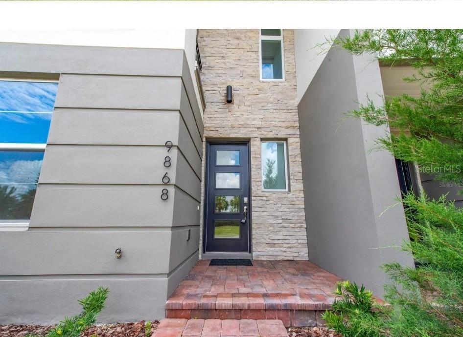 Front Entrance with lovely stone work and Contemporary door, all exterior HOA maintained