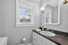 Half bath featuring vanity and toilet