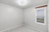 Carpeted empty room featuring baseboards
