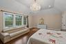 Bedroom featuring a chandelier, dark wood-type flooring, lofted ceiling, and recessed lighting