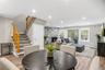 Open floor plan with dining room and living room with fireplace and sliders to new deck