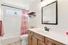 Shared full bathroom with bathtub/shower combo