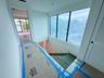 (as of April 8, 2026) the second level is seamlessly connected by the floating concrete staircase, with light pouring in from the full-height picture 