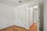 Unfurnished bedroom with light wood-type flooring and a closet