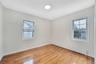 1st bedroom on 2nd floor with windows.