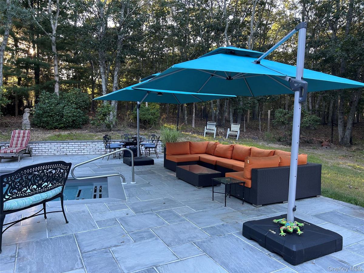 View of patio / terrace with outdoor lounge area and view of wooded area