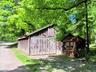 Rustic cottage featuring vertical wood siding and a pitched roof