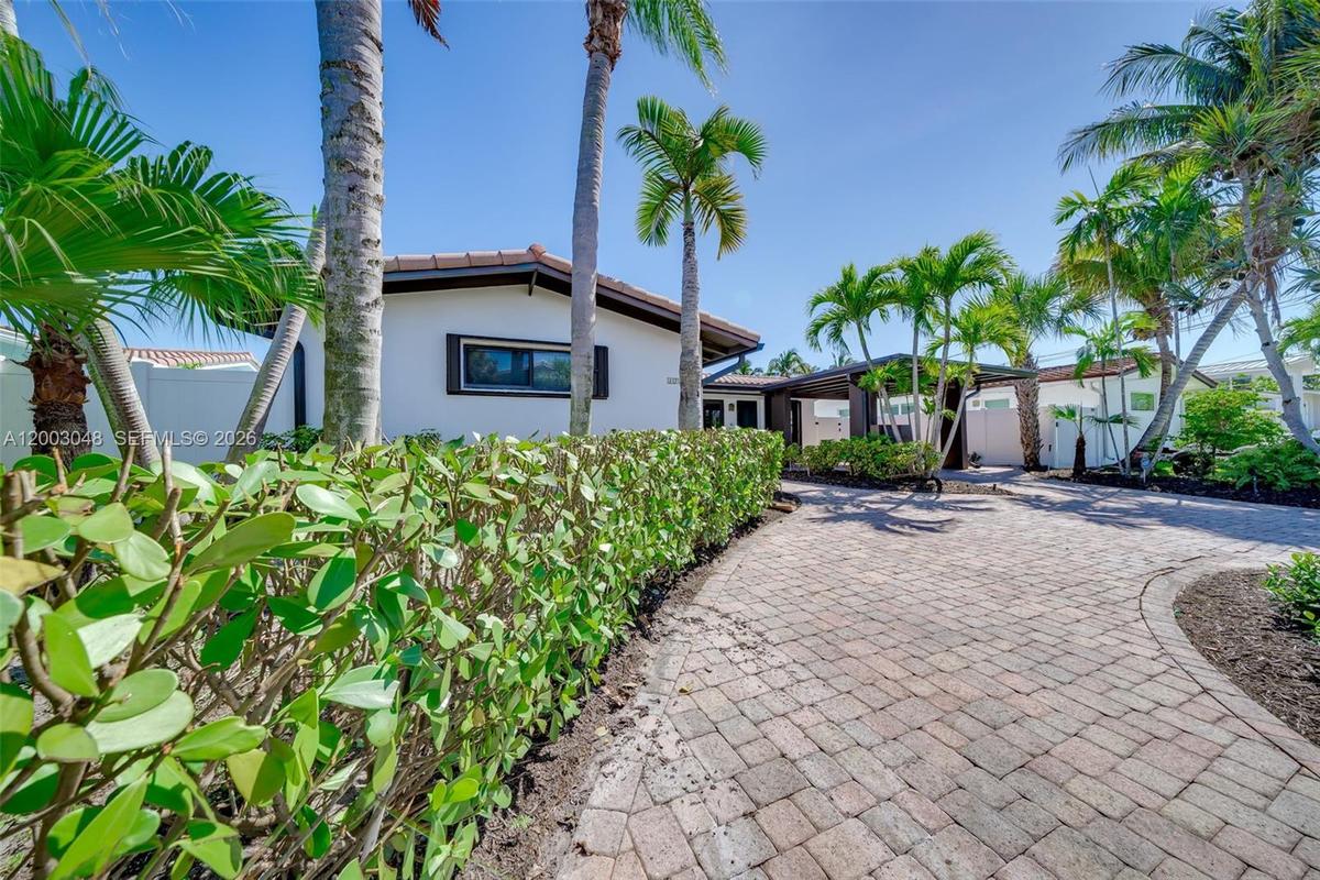 Waterfront Home | Curved Paver Driveway | Lush Tropical Gardens | South Florida